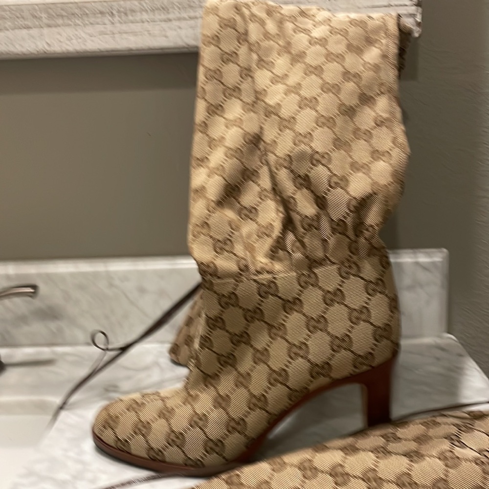 Gucci over-the-knee monogram boots.